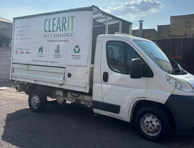 Clear It Waste Management caged tipper van with sign writing